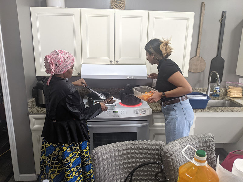 Hamtramck resident, Mwajuma teaching STAMPS student, Kayla how to cook Congolese fish, Afghani chicken and vegetables as well as Somali fried rice. 