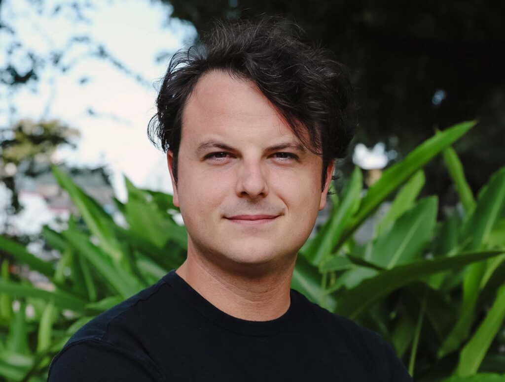 A photo of Travis Crabtree; a white male with dark hair wearing a dark shirt.