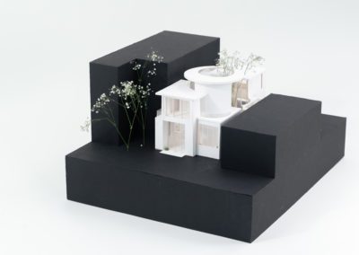 Architecture model in between black cardboard boxes
