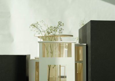 Front view of architecture model in between black cardboard boxes