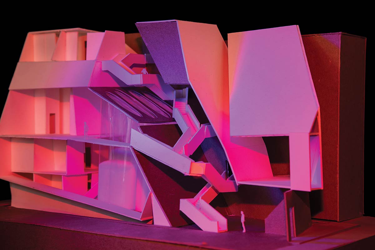 A scale model of a building lit in magenta and orange lights