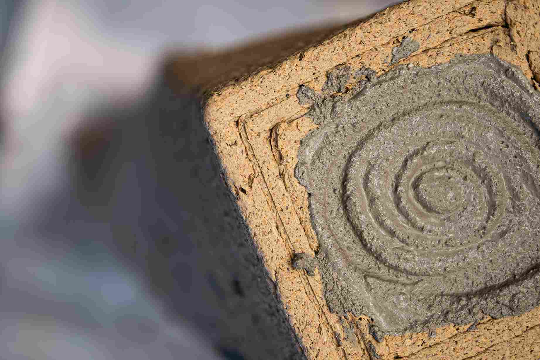 Wet concrete inside of a sawdust based form.