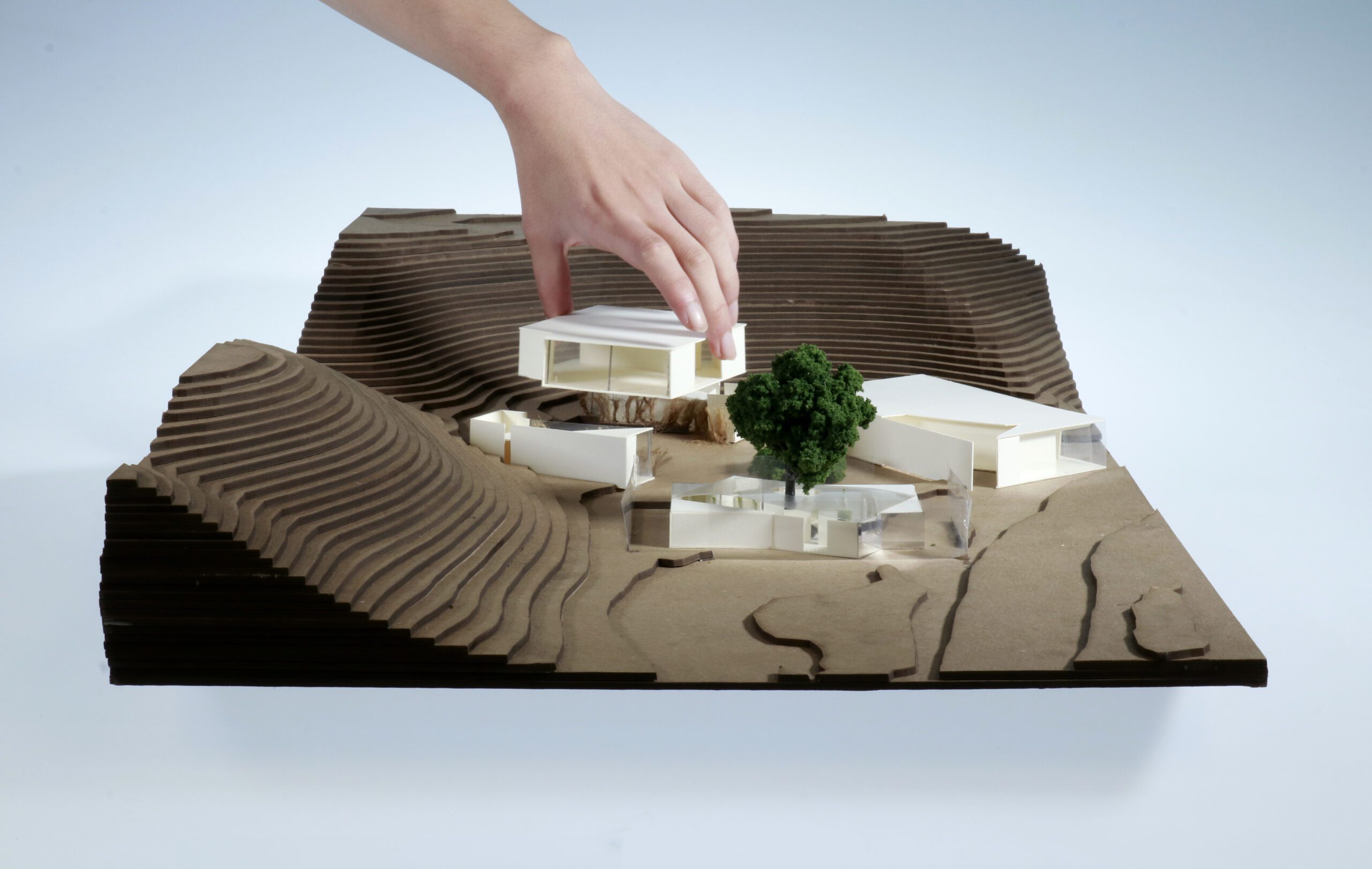 Hand placing architecture building into model