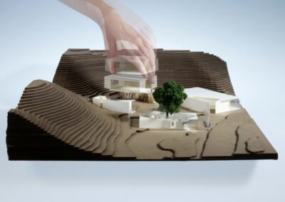 Hand in motion placing architecture building into model