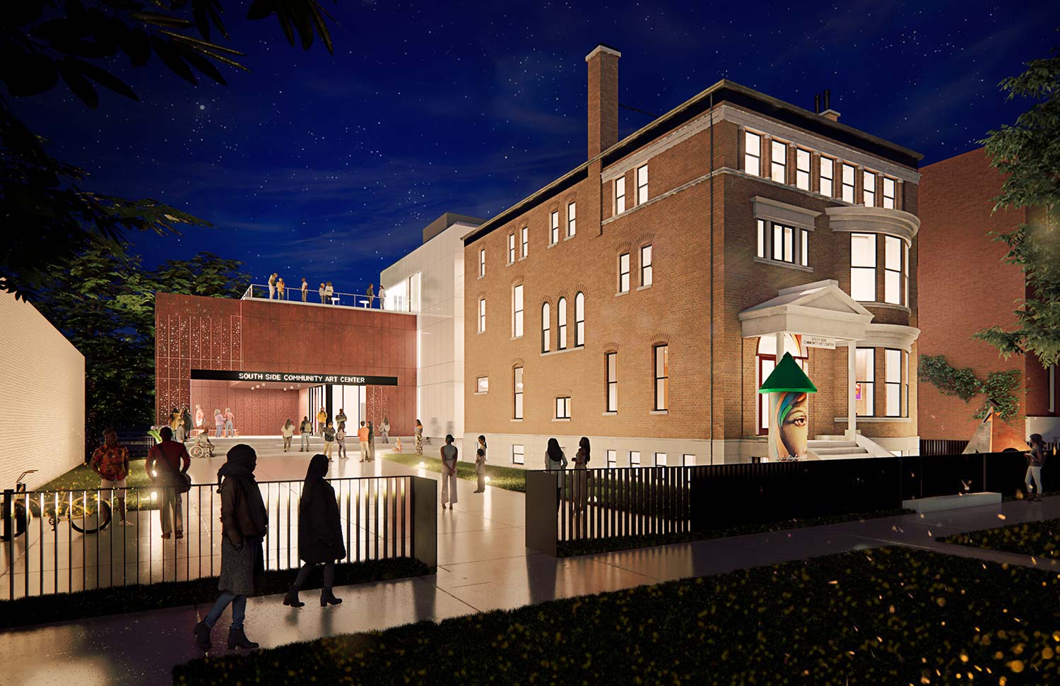 A nighttime scene of the South Side Community Art Center, featuring a historic brick building and a modern extension with people gathered outside.