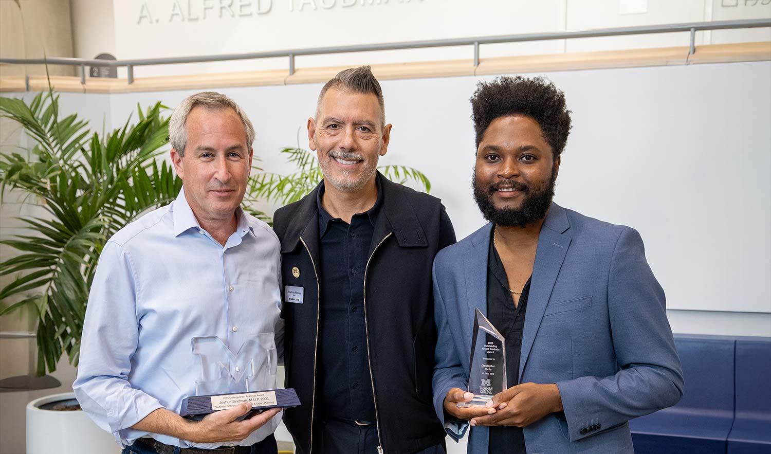 Sirefman and Locke posing with their awards and Dean Massey