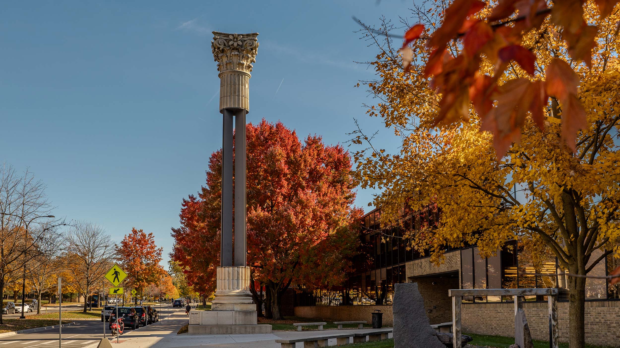 Exterior view of the Art and Architecture Building in the fall showcasing the column