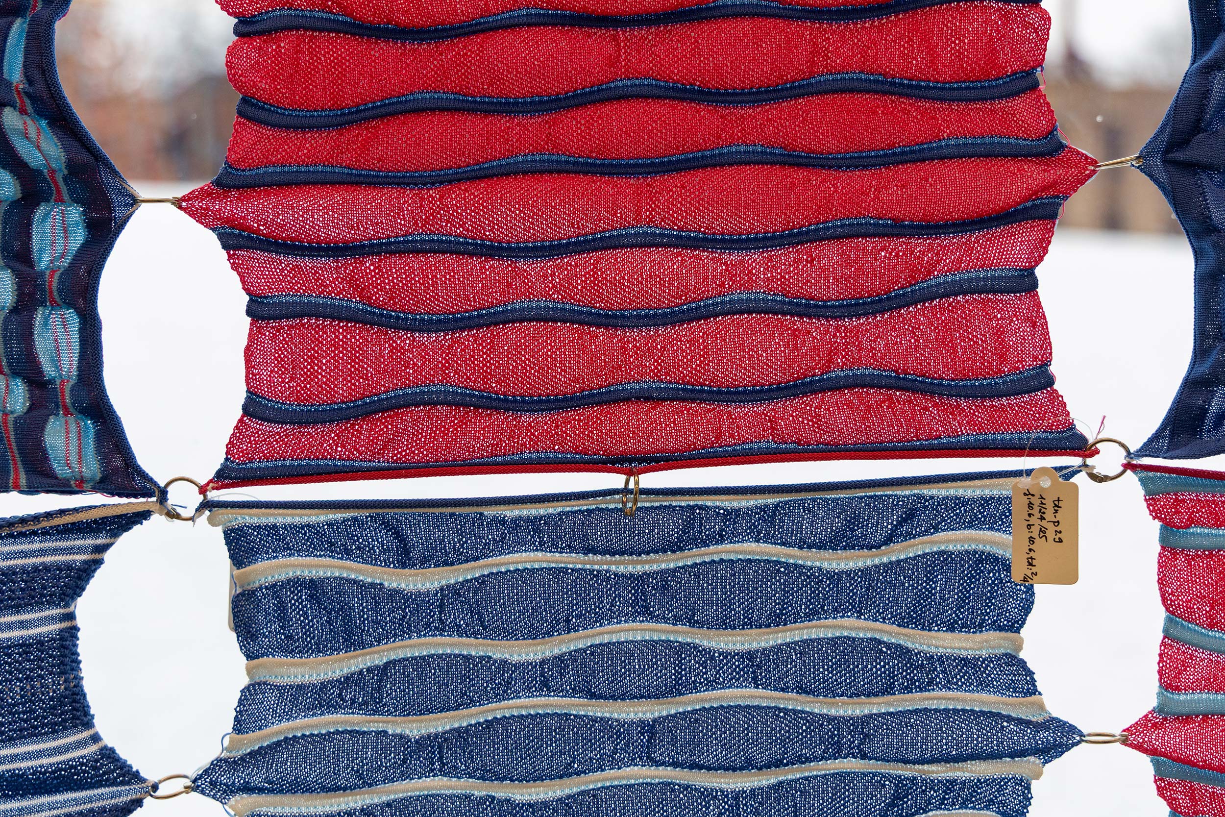 Red fabric with blue stripes and white fabric with white stripes