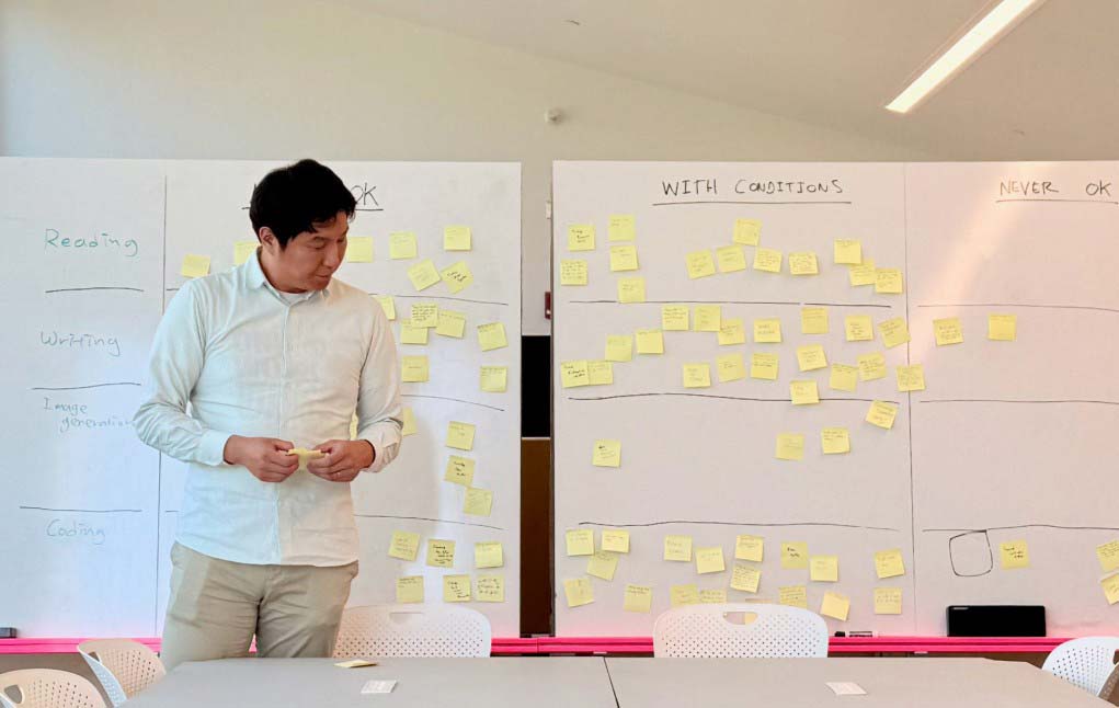 Wonyoung So standing in front of whiteboards covered in sticky notes
