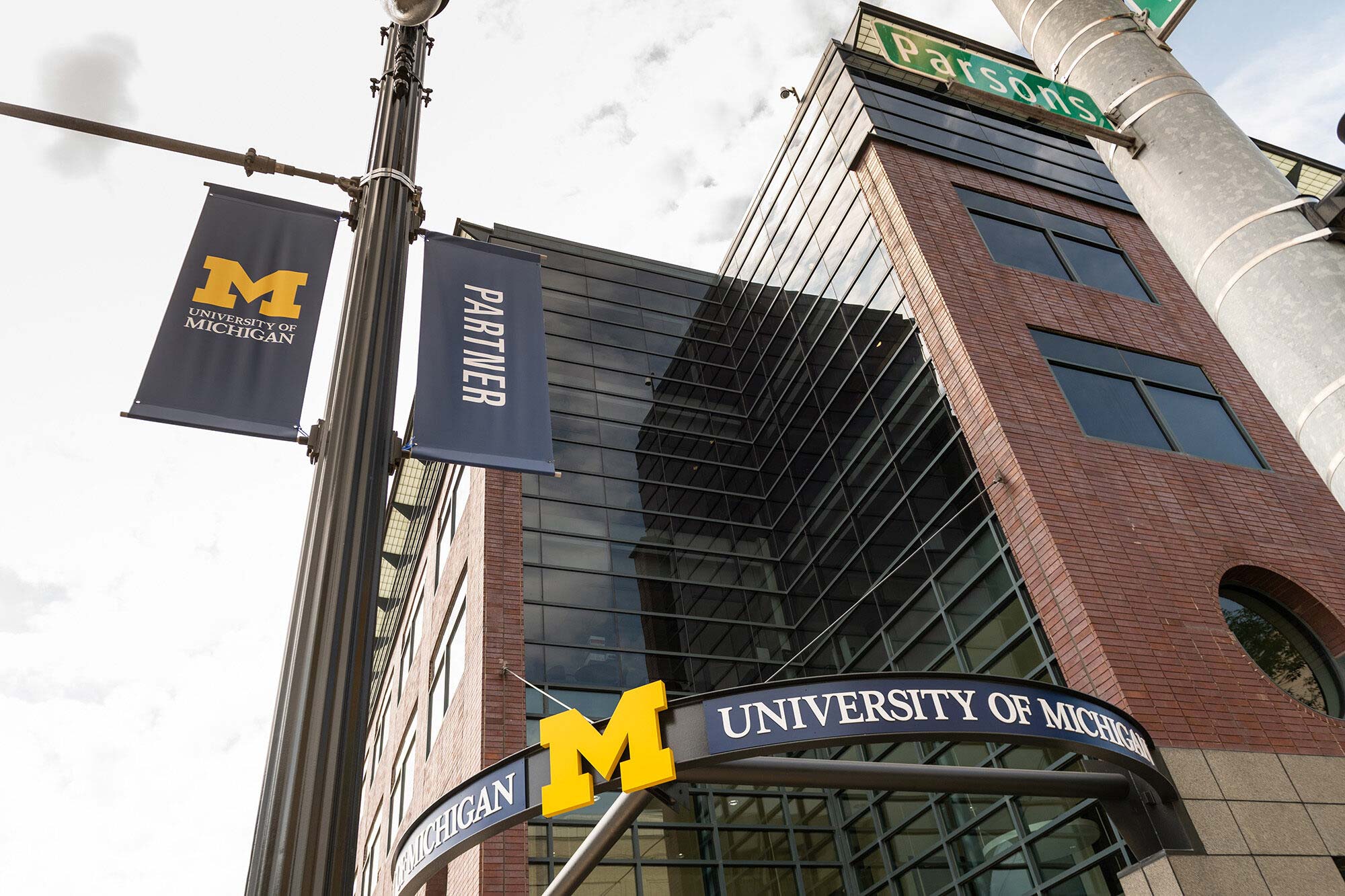 Modern office building facade featuring glass and brickwork.