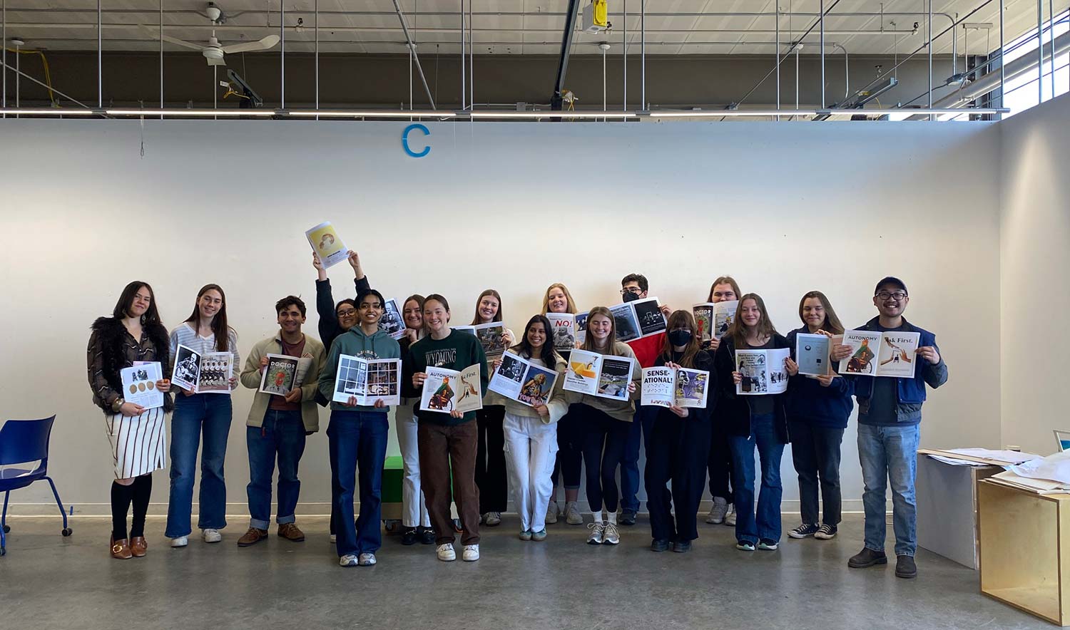 A group of people holding up advertisement papers