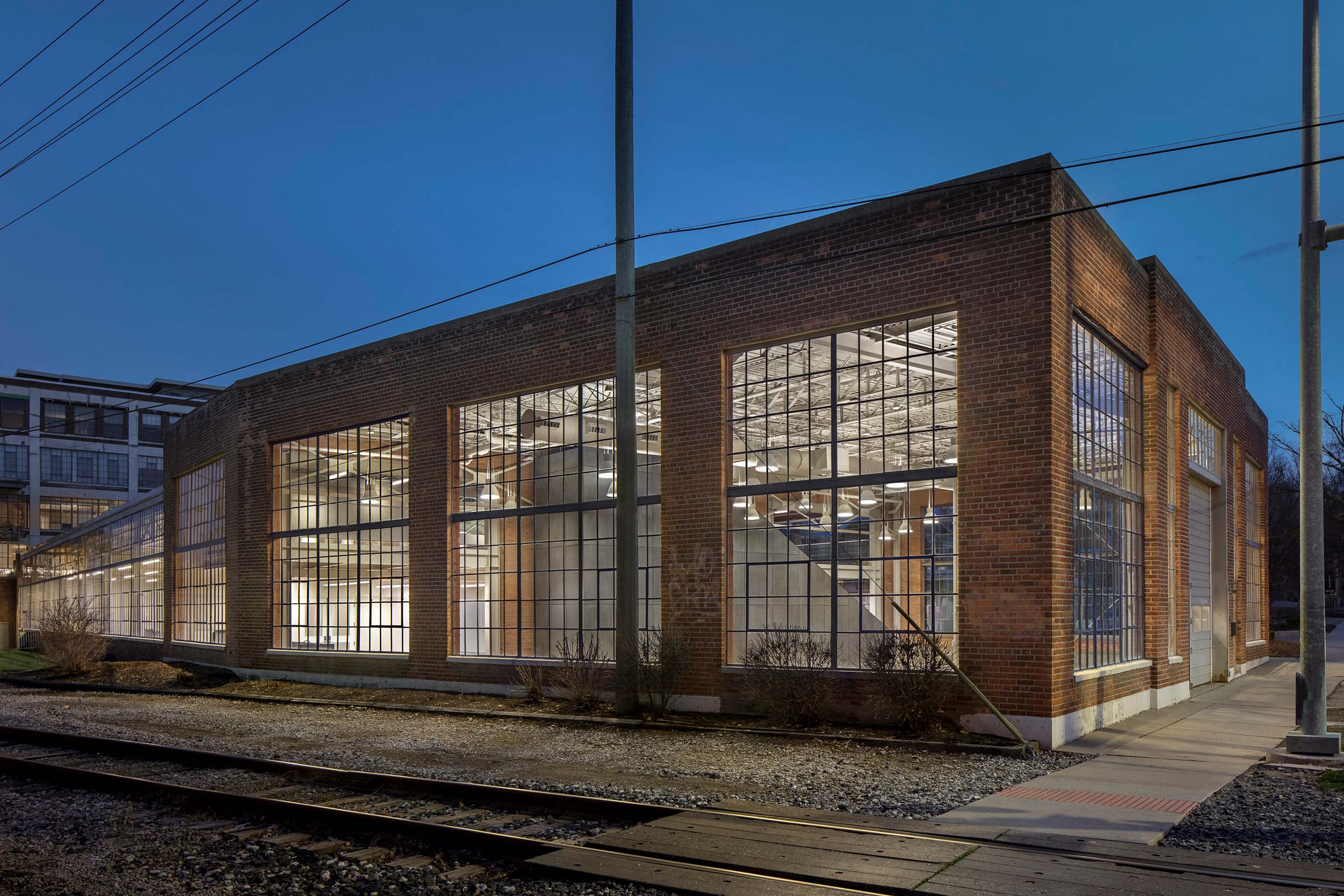 The exterior of the Liberty Annex at night. The Annex is an old brick building with large windows.