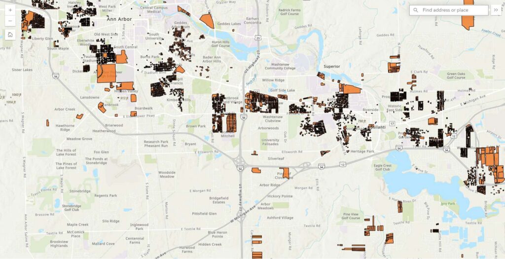 Map of Ann Arbor and Ypsilanti with dense orange mapped features clustered across several neighborhoods showing areas with racist restrictions.