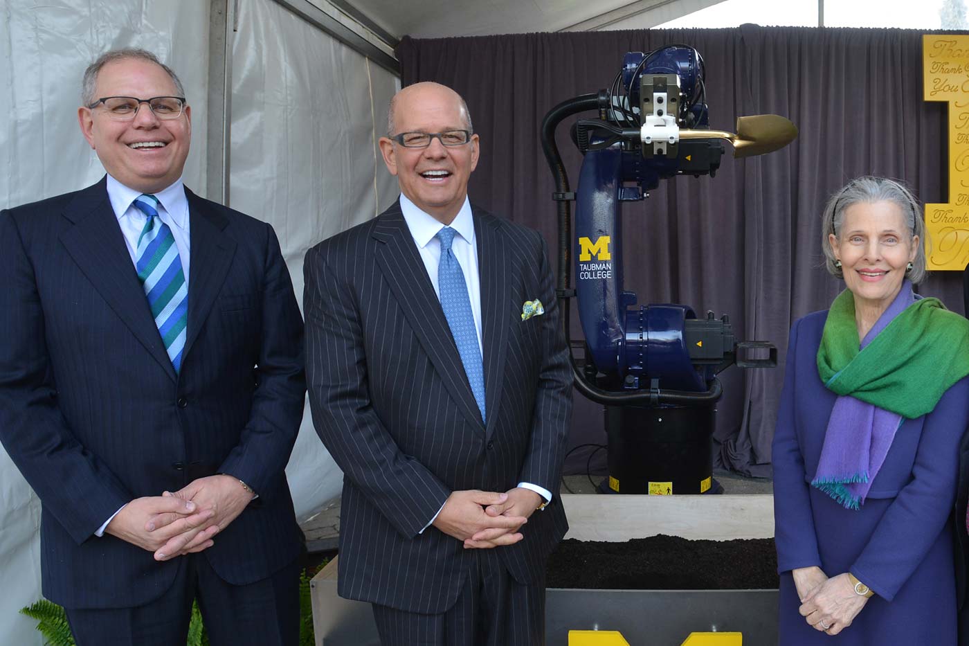 Taubman family members in front of a robot arm