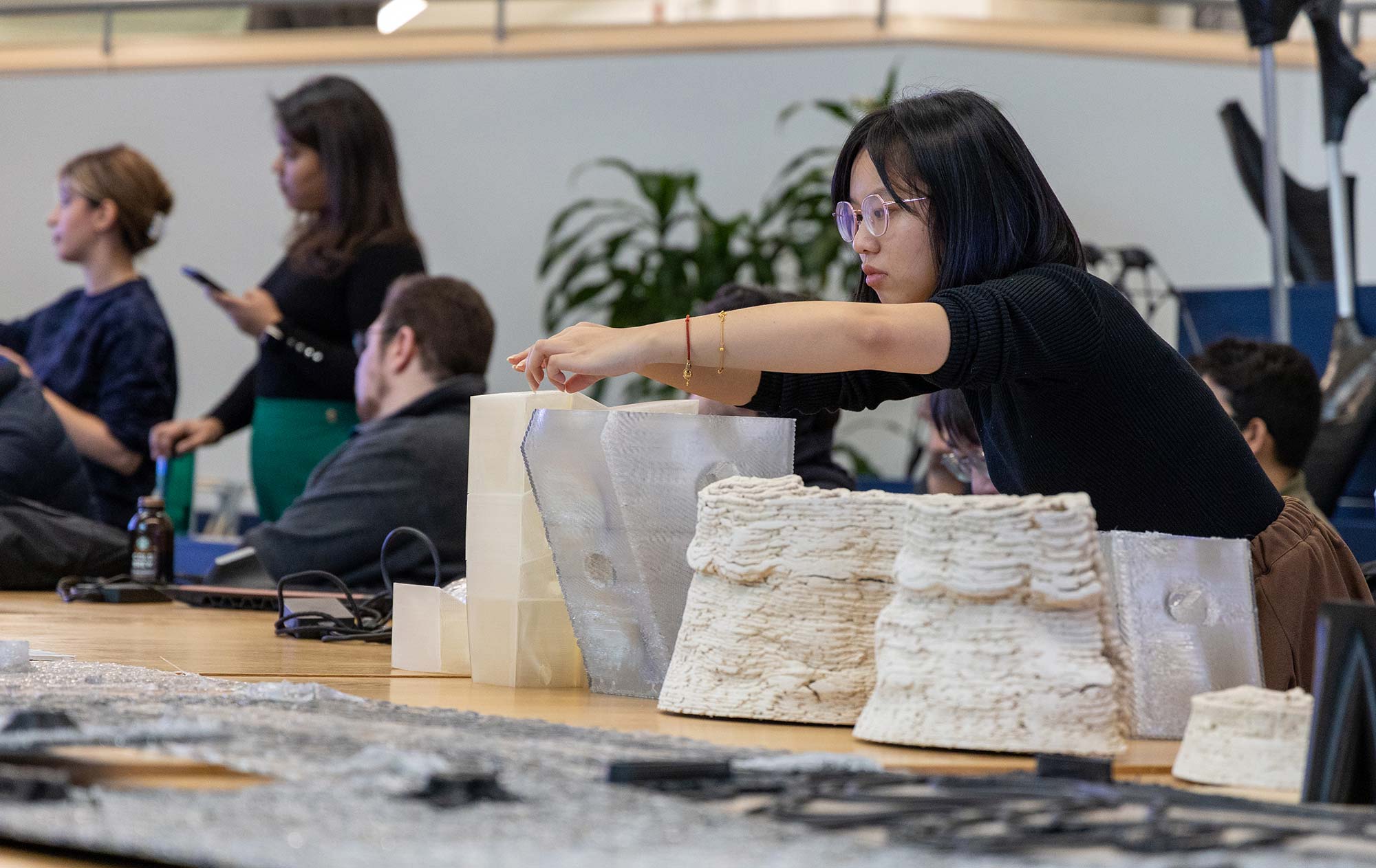 Student displaying 3D printed models