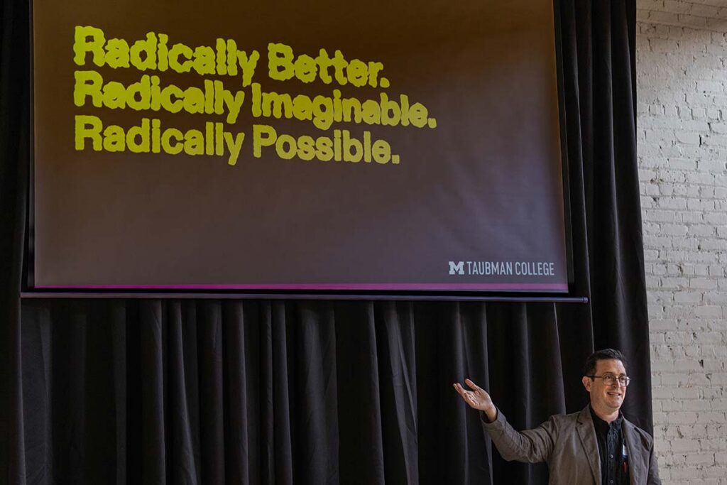 Bryan Boyer presenting in front of a slide titled "Radically Better. Radically Imaginable. Radically Possible."
