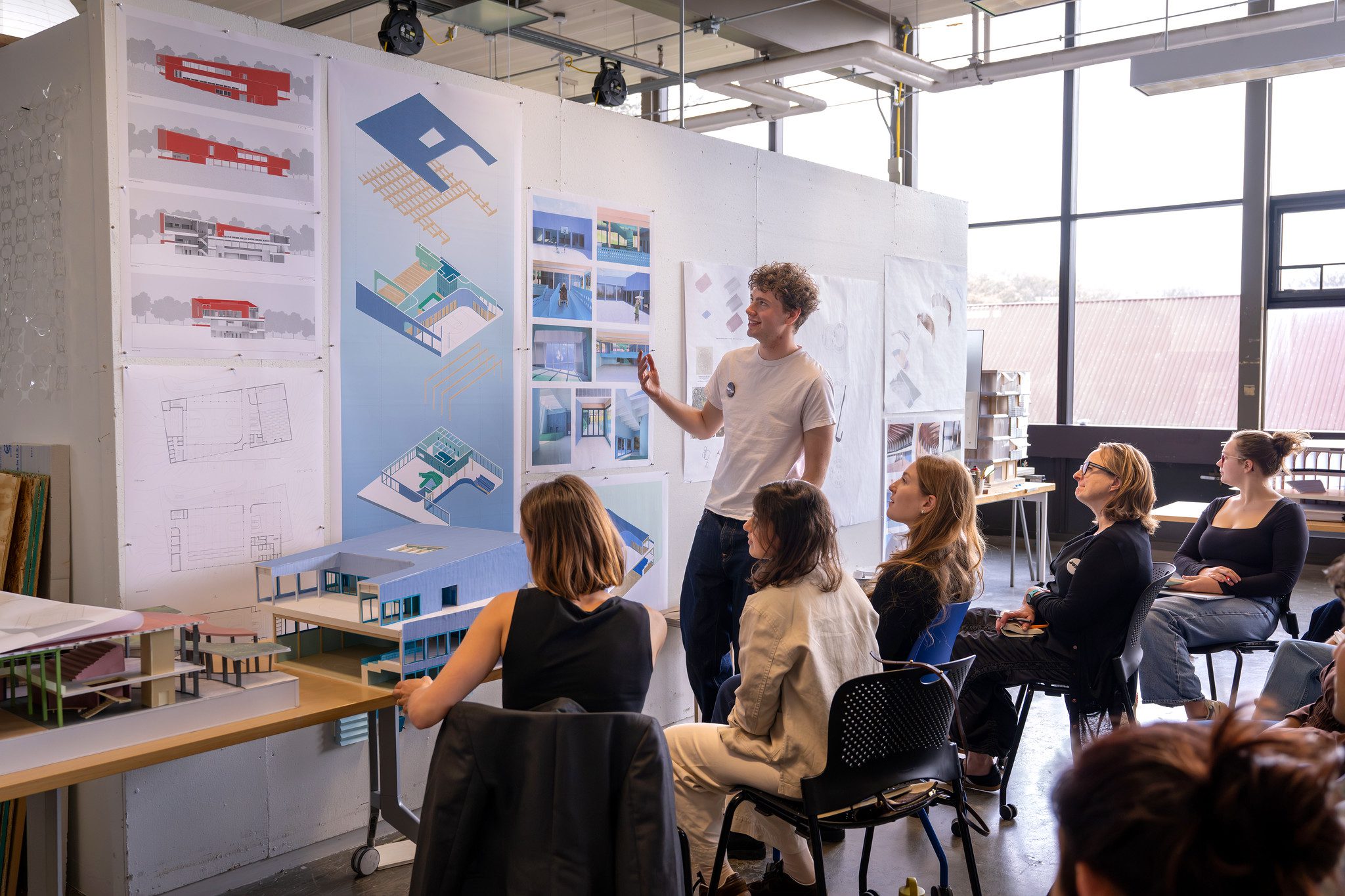 A student presents their final architecture work to faculty