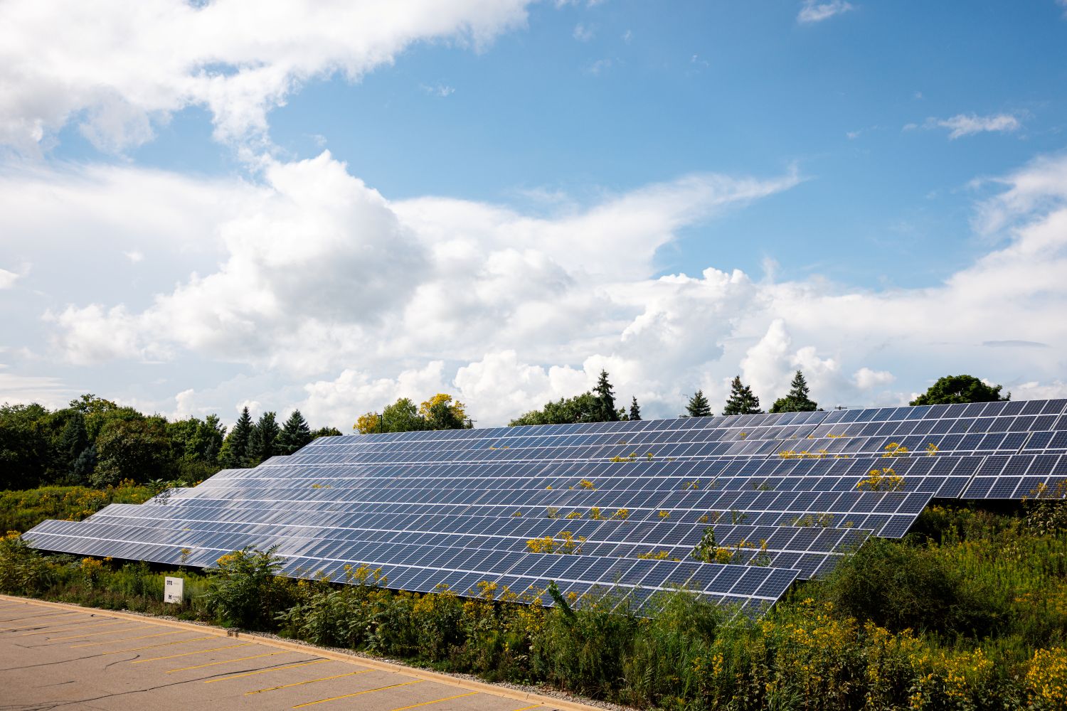 solar panels with patchy cloudy skies with spots of blue