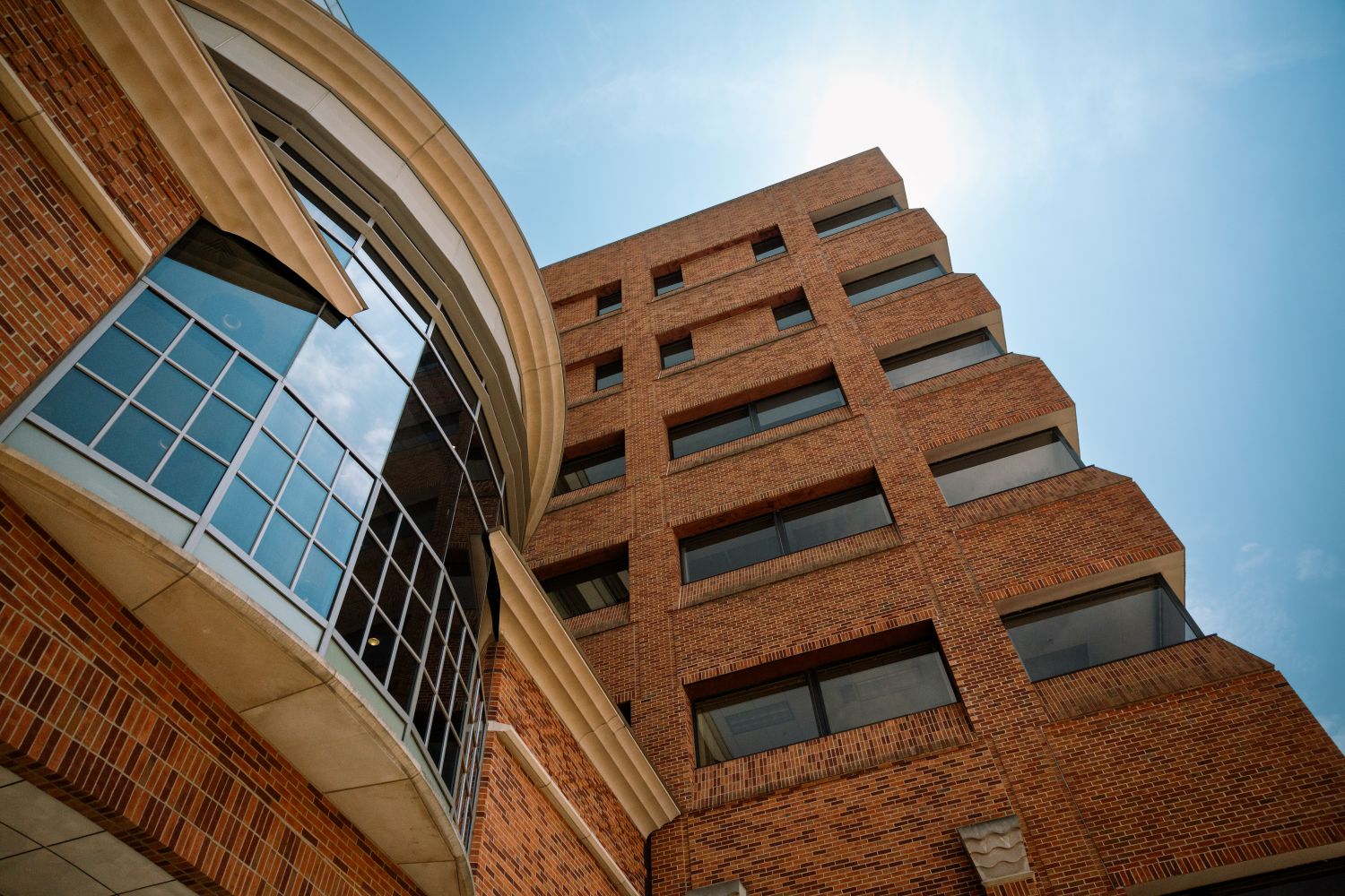 a low-angle view of a multistory brick building