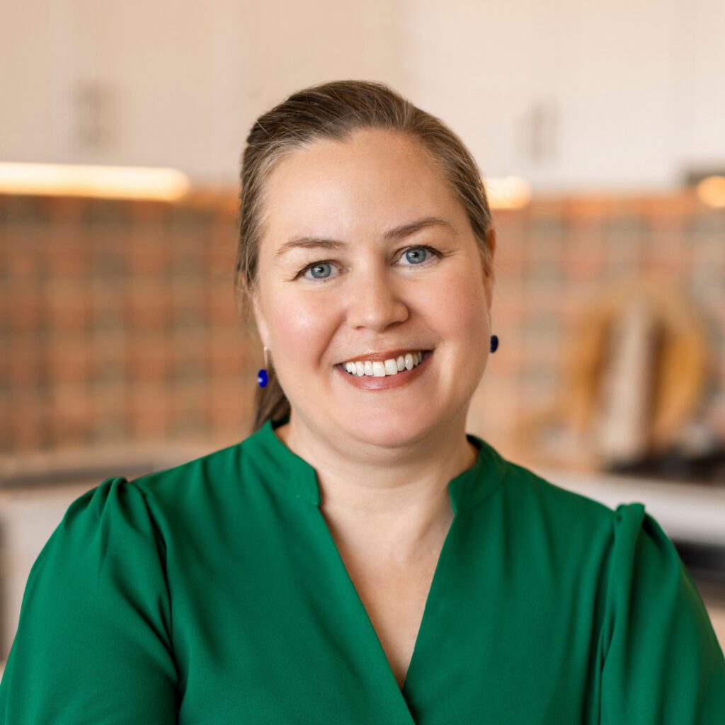 A portrait of Kristen Padavic in a green shirt